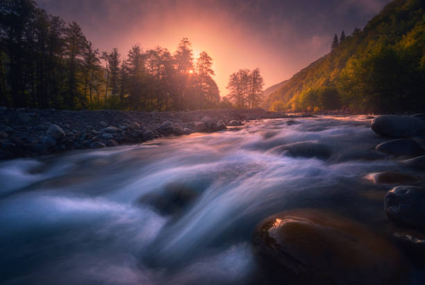 istock Magic sunrise over fast flowing mountain river 1193786508