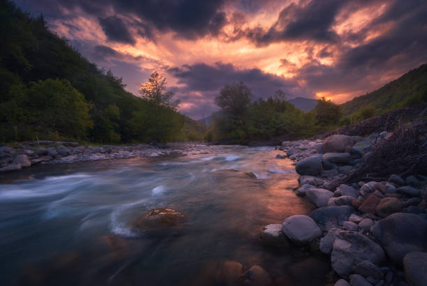 istock Magical sunset over fast flowing mountain river 1193786534