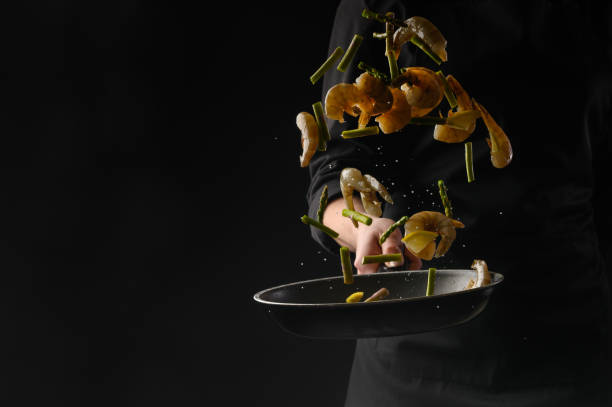 istock Seafood, shrimp frying, chef on a black background 1193788154