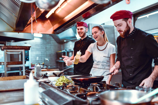 istock Female Laughing While Preparing Meal In Kitchen 1193789398