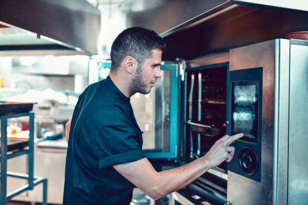 istock Male Baker Preheating The Oven 1193789475