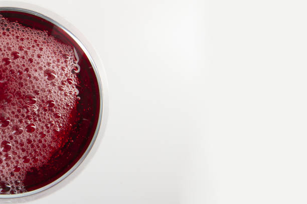 istock Glass of red wine with shadow. Top view. Abstract red wine bubbles. 1193789507