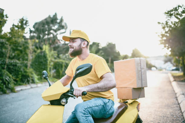Young Mailman On Scooter Delivering Packages