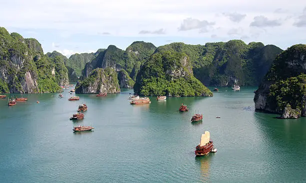 Cruise tourist boats at Halong bay area  in  Halong city, Vietnam. Halong bay is made of 3000 limestone islands.