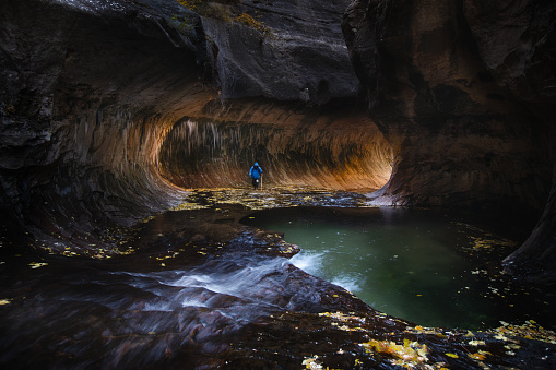 This is the picture of a hiker in subway trail in Zion National Park, Utah, USA