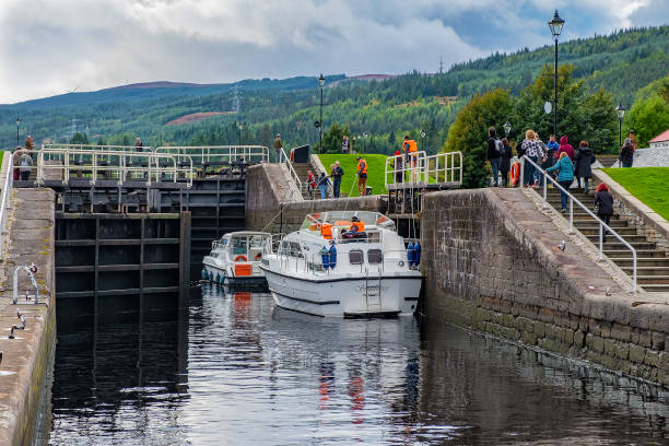 Scotland Fort Augustus, Scotland, UK - October 15, 2019: two small motor boats going through series of locks. fort augustus stock pictures, royalty-free photos & images
