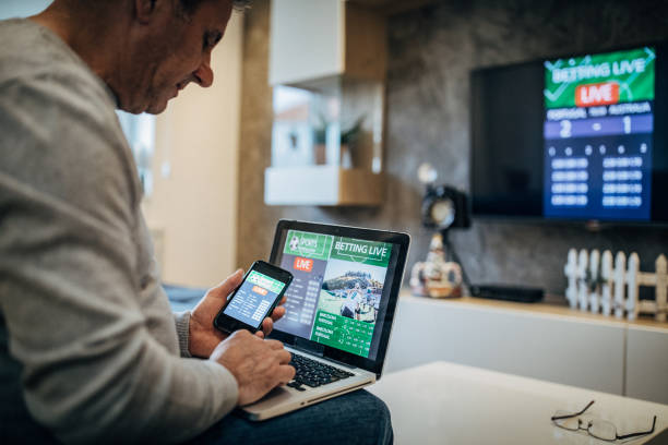 istock Mature man using mobile app for live betting 1193801013