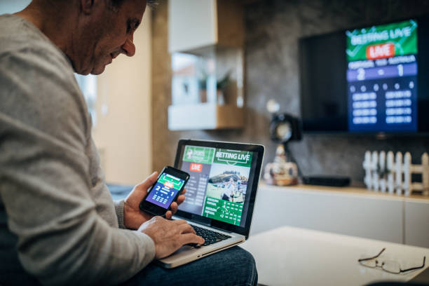 istock Mature man using mobile app for live betting 1193801031