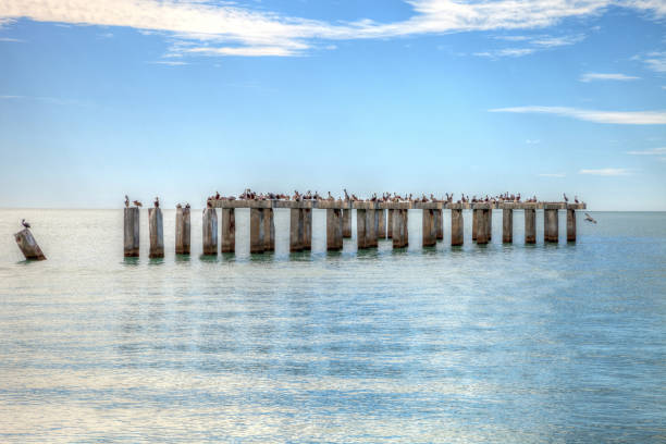 Old abandoned stone fishing pier called Bocahenge is L shaped and found in Boca Grande on Gasparilla Island in Florida