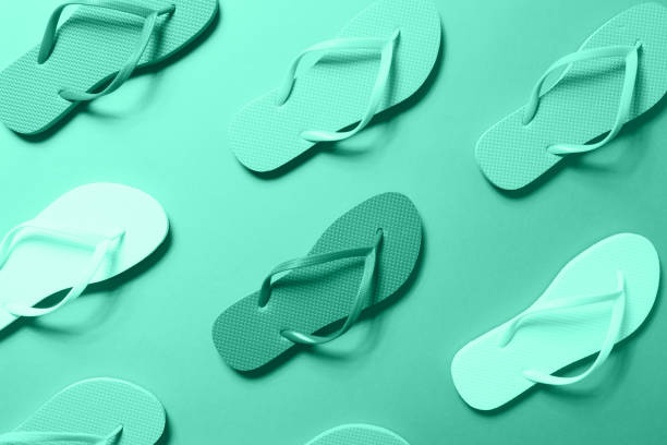 istock Multicolor flip flops on the solid background toned in trendy seasonal color, monochrome image 1193802151