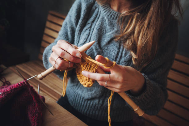 istock Close up on woman's hands knitting 1193802158