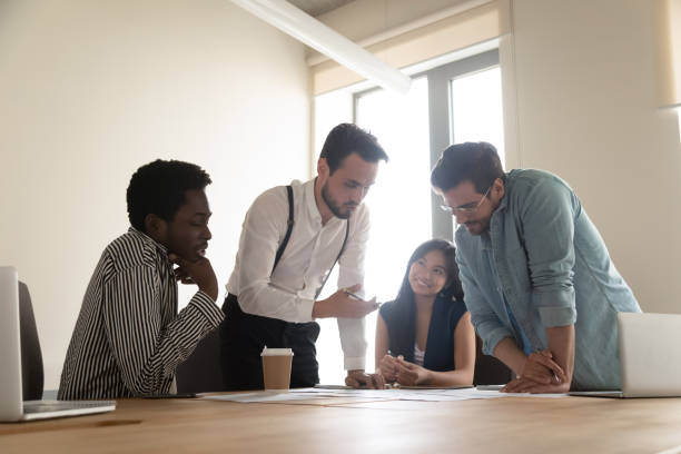 istock Multiracial employees talk brainstorming at team briefing in office 1193802302