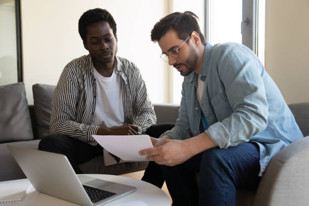 istock Diverse male colleagues discuss paperwork in office 1193802322