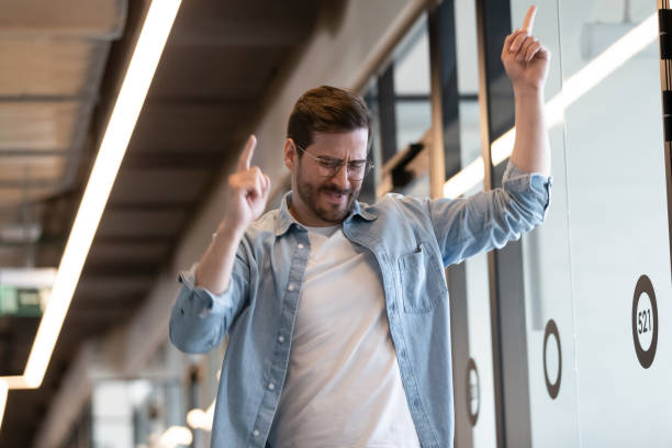 istock Funny millennial businessman perform winner dance in office 1193802342