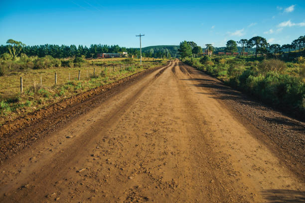 istock Deserted dirt road passing through rural lowlands 1193805935