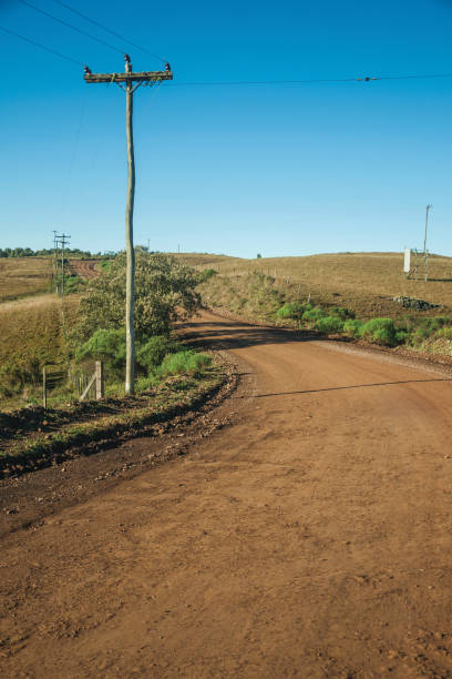istock Deserted dirt road passing through rural lowlands 1193807478