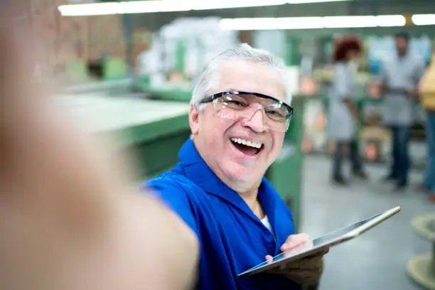 Photo of Portrait of an engineer taking selfies in a factory