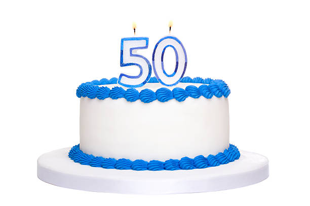 istock A 50th white birthday cake with blue piping and candles  119381519