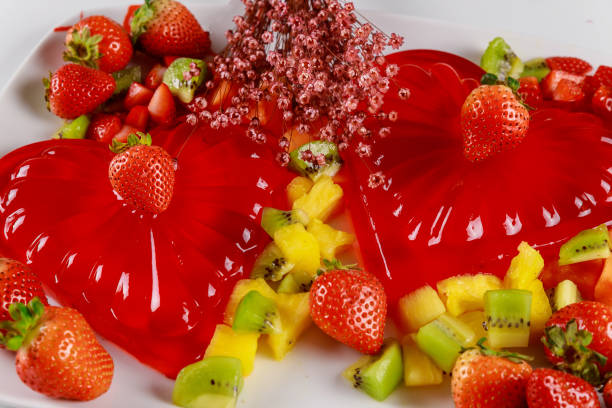 strawberry gelatin hearts with fresh strawberries and pineapple. - raspberry heart shape gelatin dessert valentines day imagens e fotografias de stock