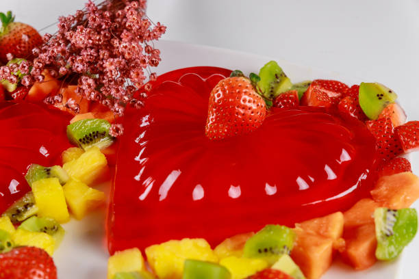 strawberry heart gelatin with fruits and flowers on valentines day. - raspberry heart shape gelatin dessert valentines day imagens e fotografias de stock