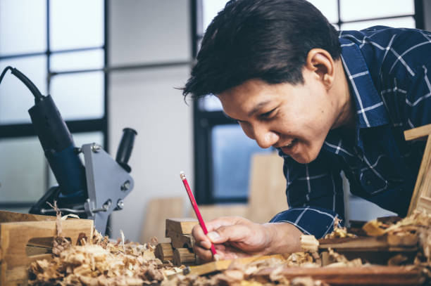 istock A carpenter is designing and working on hand-made wood. 1193816149