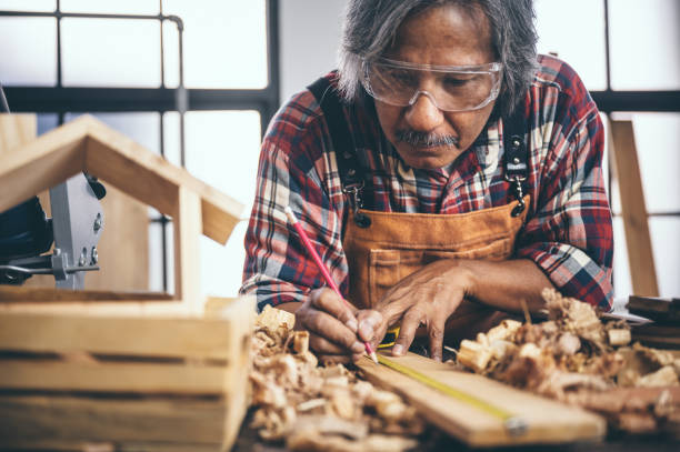 istock A carpenter is designing and working on hand-made wood. 1193816186