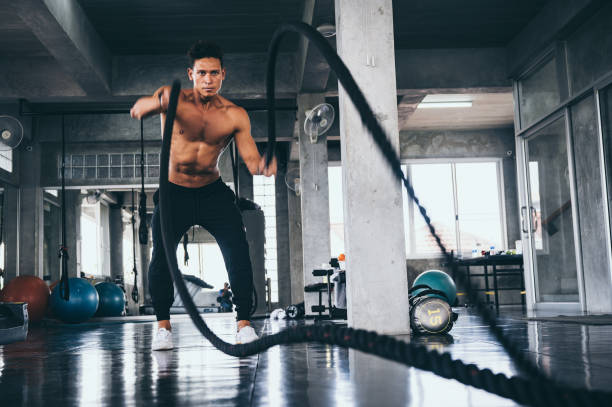istock Strong man exercising in the sport gym 1193816221