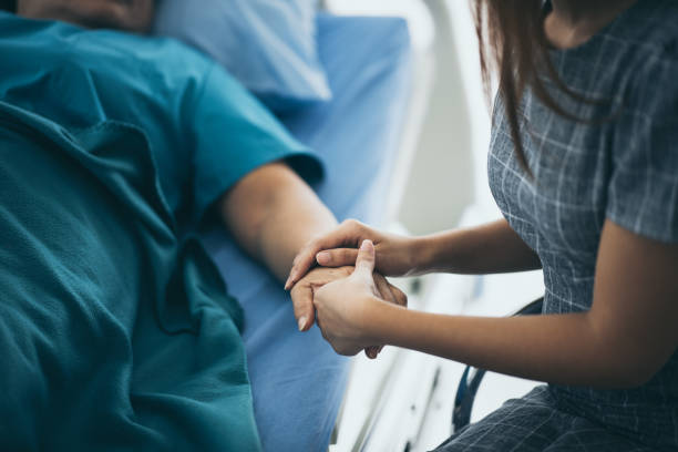 istock Doctor or nurse holding elderly lady's hands. 1193816313