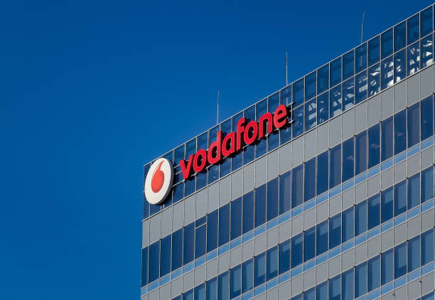 Vodafone headquarters, in Bucharest, Romania. Bucharest, Romania - December 09, 2019: A logo of Vodafone, British telecommunications company, is seen on the top of Globalworth Tower building, in Bucharest. This image is for editorial use only. bucharest photos stock pictures, royalty-free photos & images