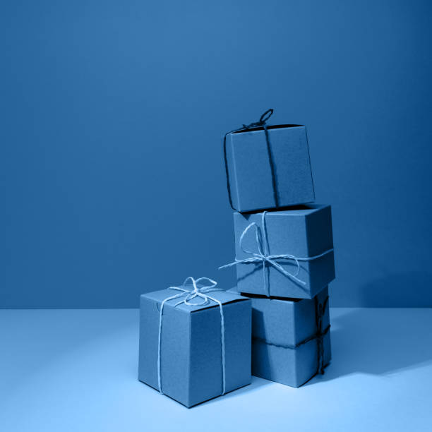 istock Craft cardboard gift boxes on the solid classic blue  background. Holiday and gift concept 1193821327