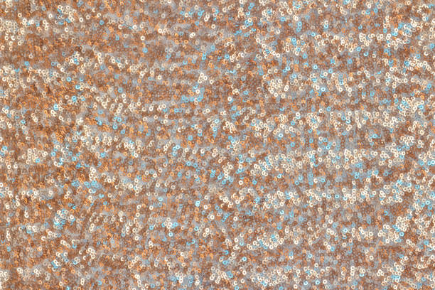 istock Abstract festive background with round sequins with color transition. Cooper and turquoise colors. 1193821481