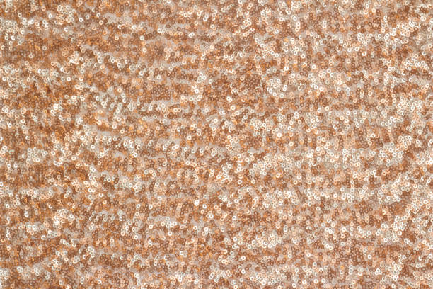 istock Abstract festive background with round sequins with color transition. Copper and beige colors. 1193822325