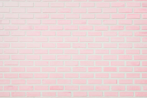 Pastel Pink and White brick wall texture background. Brickwork or stonework flooring interior rock old pattern clean concrete grid uneven bricks design stack.