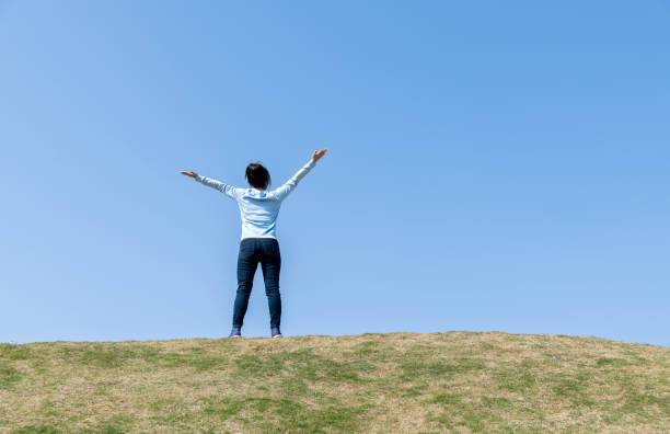 istock Young woman relaxing with arms outstretched 1193826780