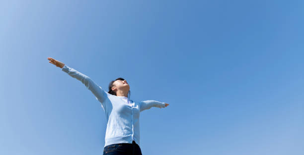 istock Young woman relaxing with arms outstretched 1193826891