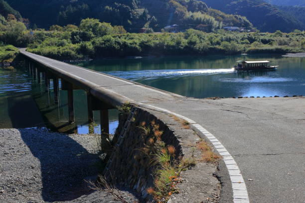 istock A ’YAKATABUNE’ that passes through the Misato subsidence bridge(Shimanto City, Kochi Prefecture) 1193835399