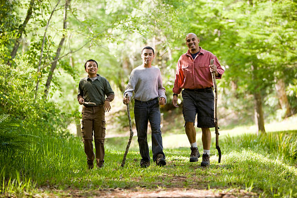istock Hispanic father and sons hiking on trail in woods 119383813