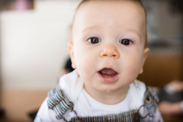 istock Young cute infant boy smiles in casual home setting 1193839869