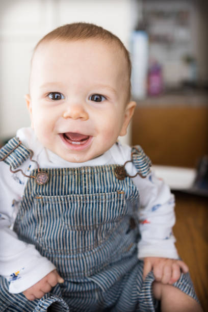 istock Young cute infant boy smiles in casual home setting 1193839870