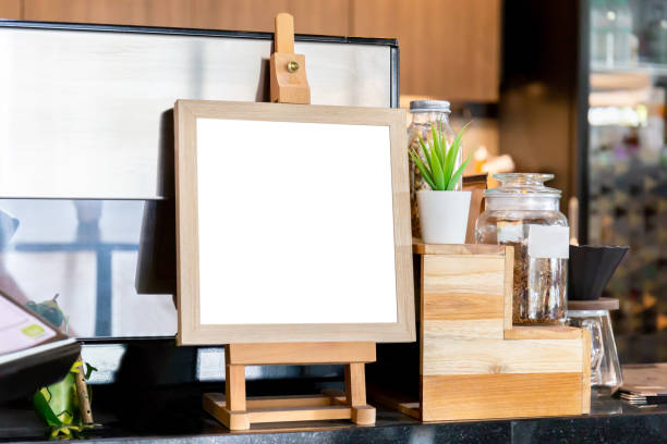 istock Blank wood frame stand mockup poster display in coffee shop 1193841947