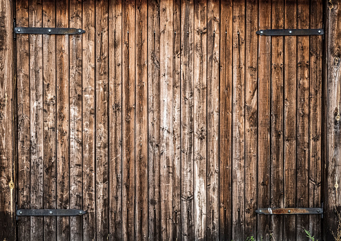 The faded gate of an old wooden house.