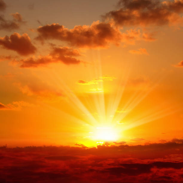 istock orange sunset sky with rays of sun 1193843564