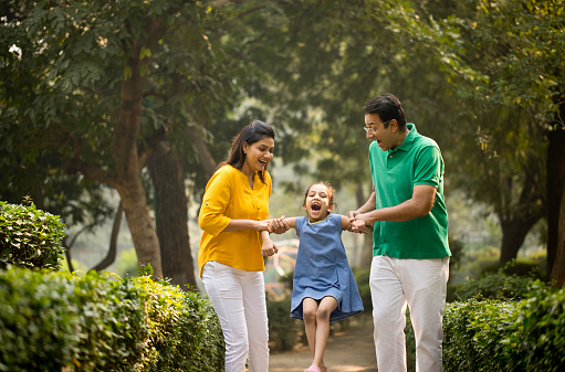 Excited Indian family playing at park
