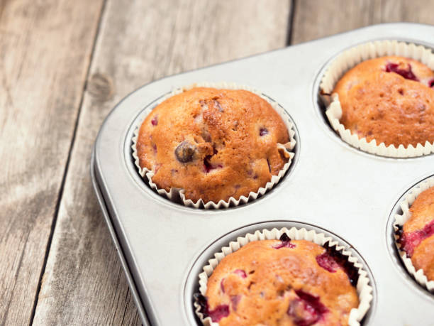 istock Freshly baked cherry muffins closeup in baking tray 1193844684
