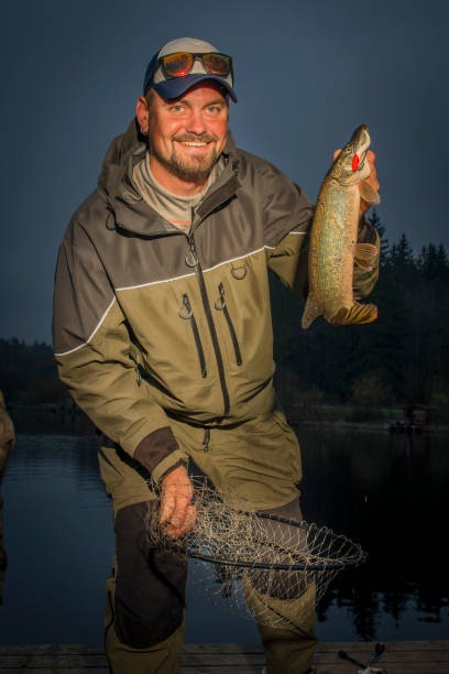 istock A man with a pike caught on spinning. 1193853739
