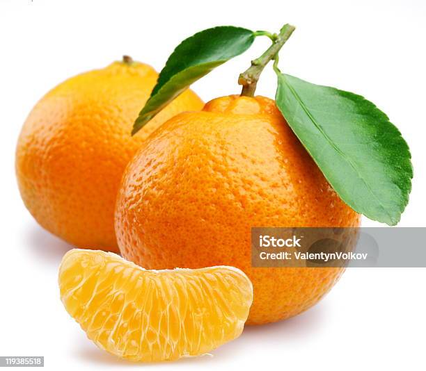 Two Ripe Tangerines With Tangerine Wedge On White Background Stock Photo - Download Image Now