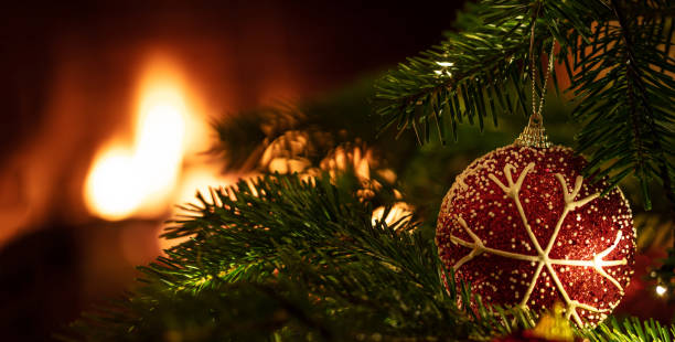 istock Christmas tree close up on blur glowing fire background 1193855422