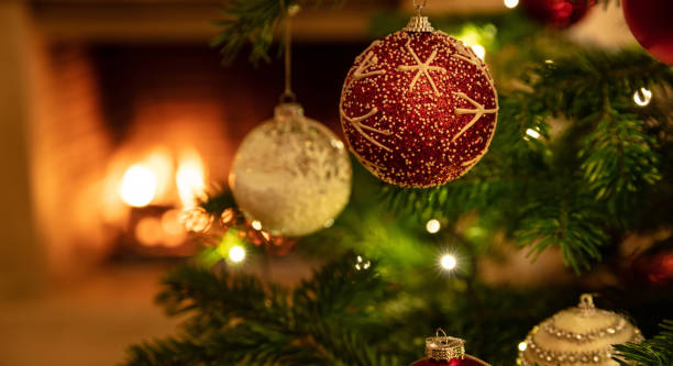 istock Christmas tree close up on burning fireplace background 1193855445
