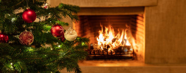 istock Christmas tree close up on burning fireplace background 1193855465