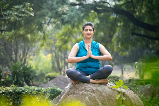 istock Beautiful woman meditating at park 1193857628